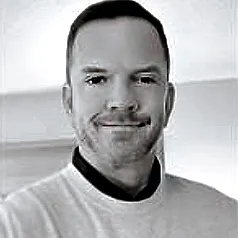 Picture of Jeff Daniel in black and white. He's wearing a sweater with a 5 o'clock shadow.